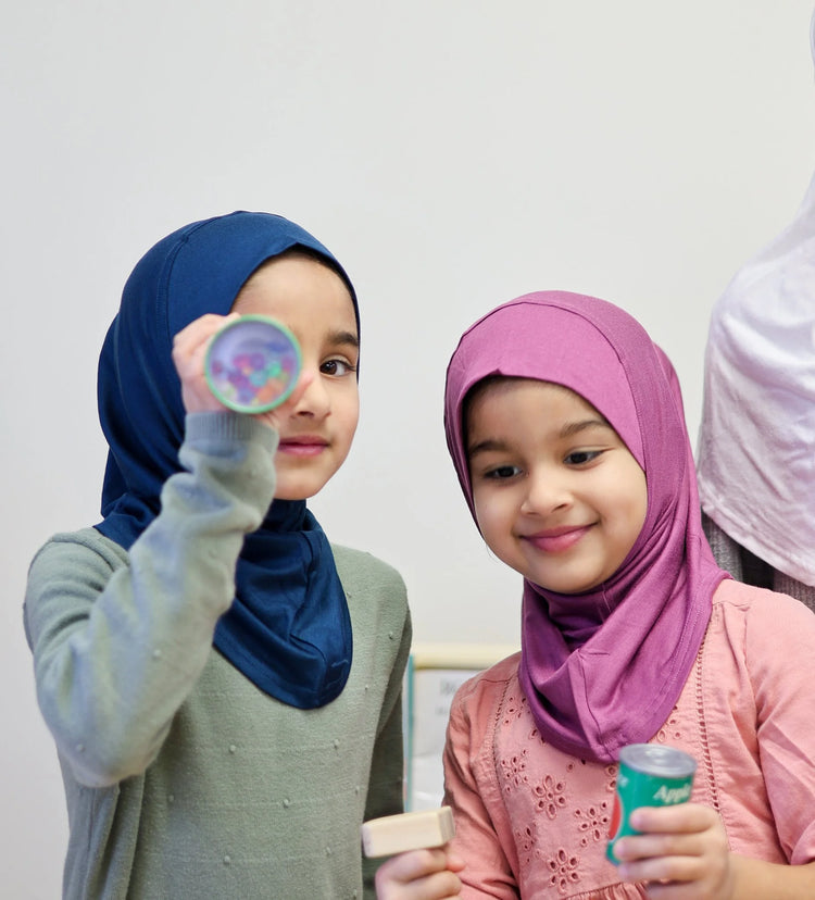 Two girls wearing Aaliya slip-on hijabs in navy and berry